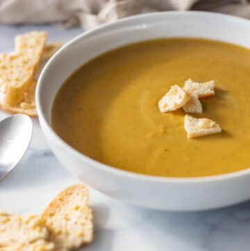 Bowl of hot butternut soup with croutons